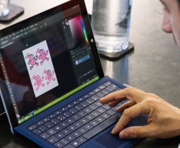 An artist working on a laptop